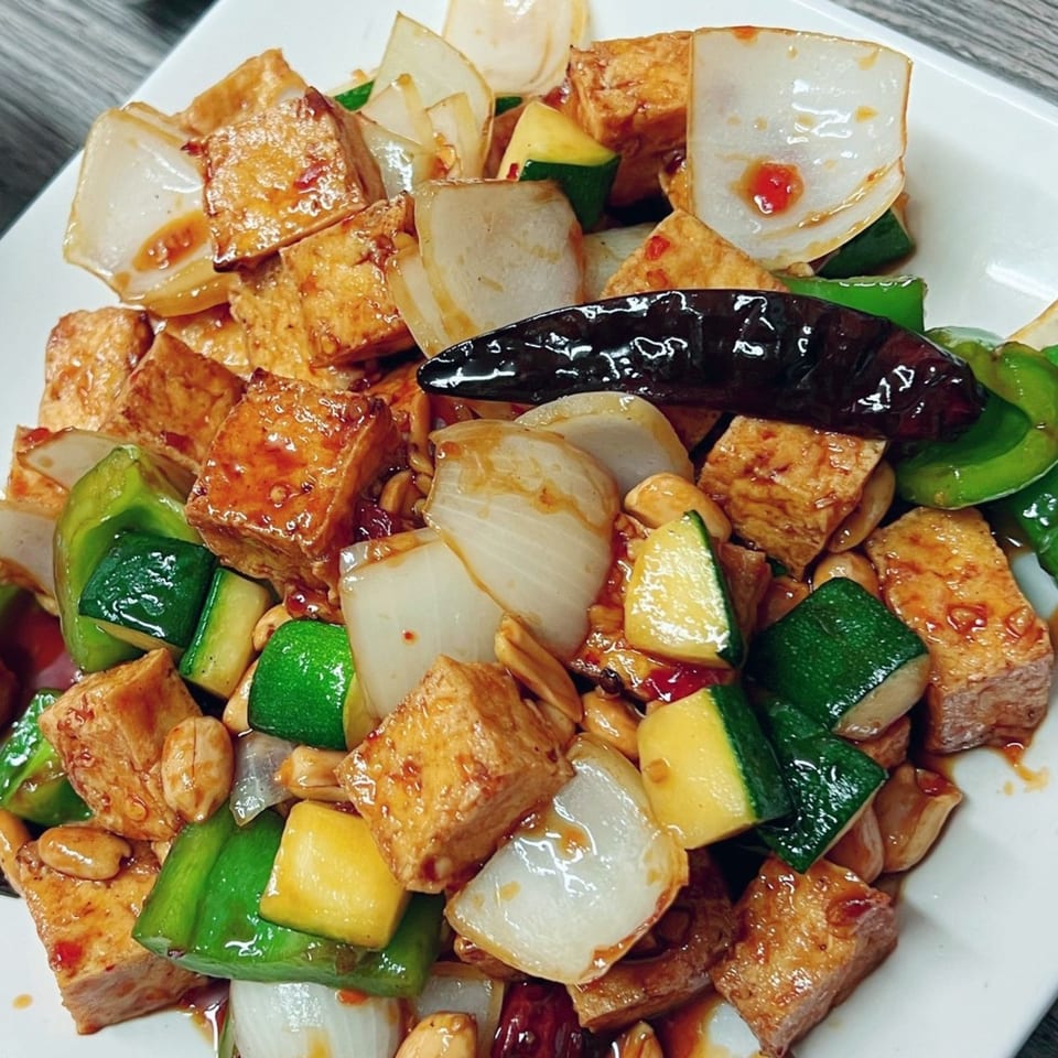 Golden Pho's Kung Pao Tofu with bell peppers, zucchini, onions, peanuts, and a dried chili.