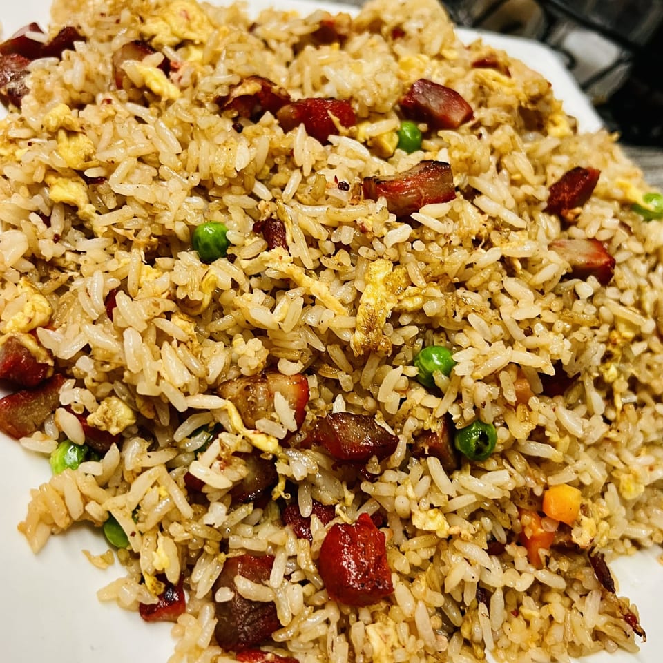 Close-up of Golden Pho's Vietnamese fried rice with char siu pork, egg, and peas.